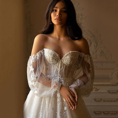 Luxury Wedding Dress. Sequined Long Sleeve Lace Bridal Dress. Long train wedding dress with off-the shoulders sweetheart neckline and long sleeves.